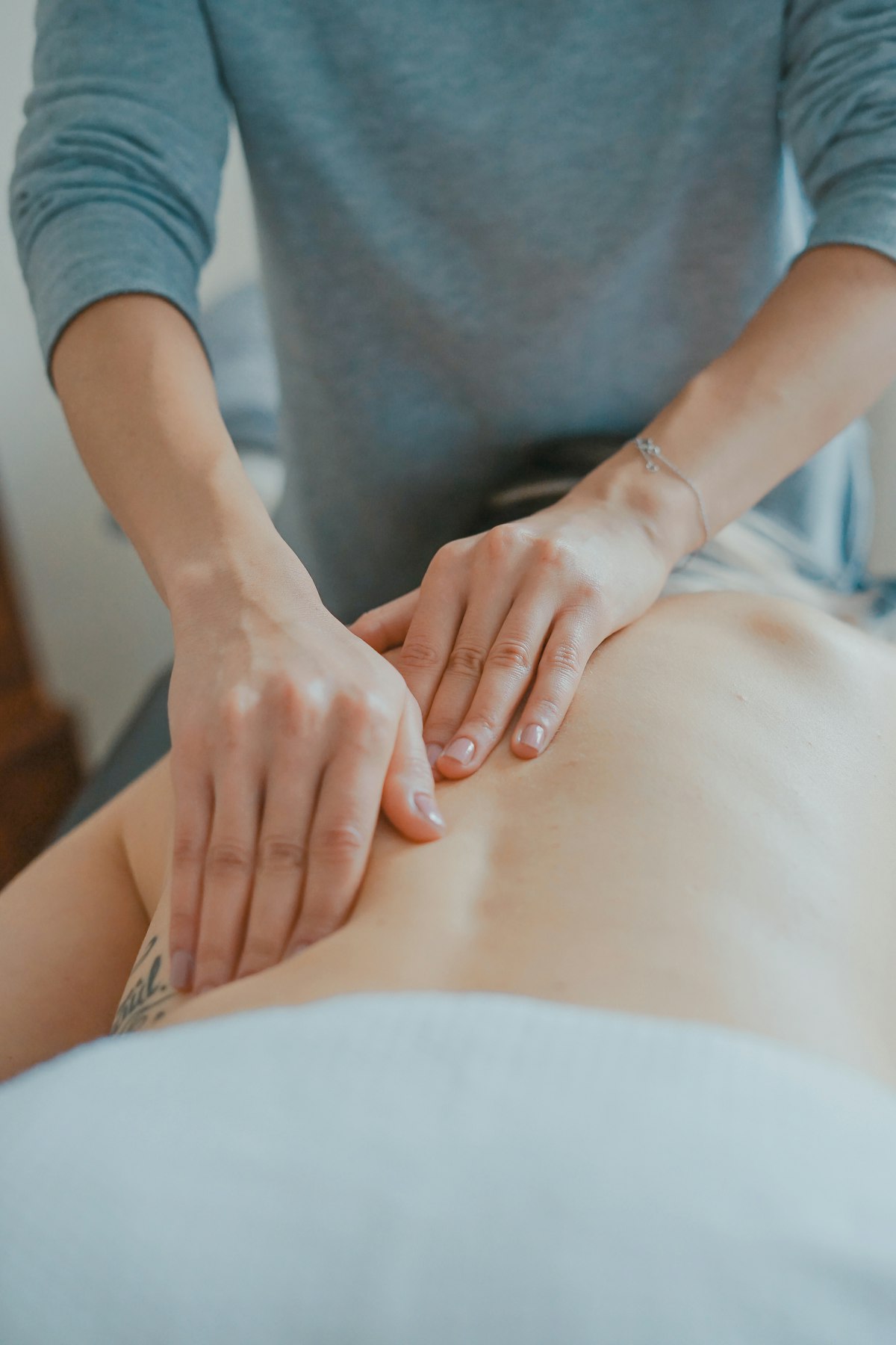 Spa therapist delivering a hands-on massage treatment
